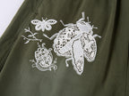 Lace insect and floral motif curved denim pants