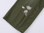 Lace insect and floral motif curved denim pants