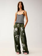 Lace insect and floral motif curved denim pants