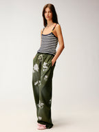 Lace insect and floral motif curved denim pants