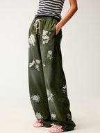 Lace insect and floral motif curved denim pants