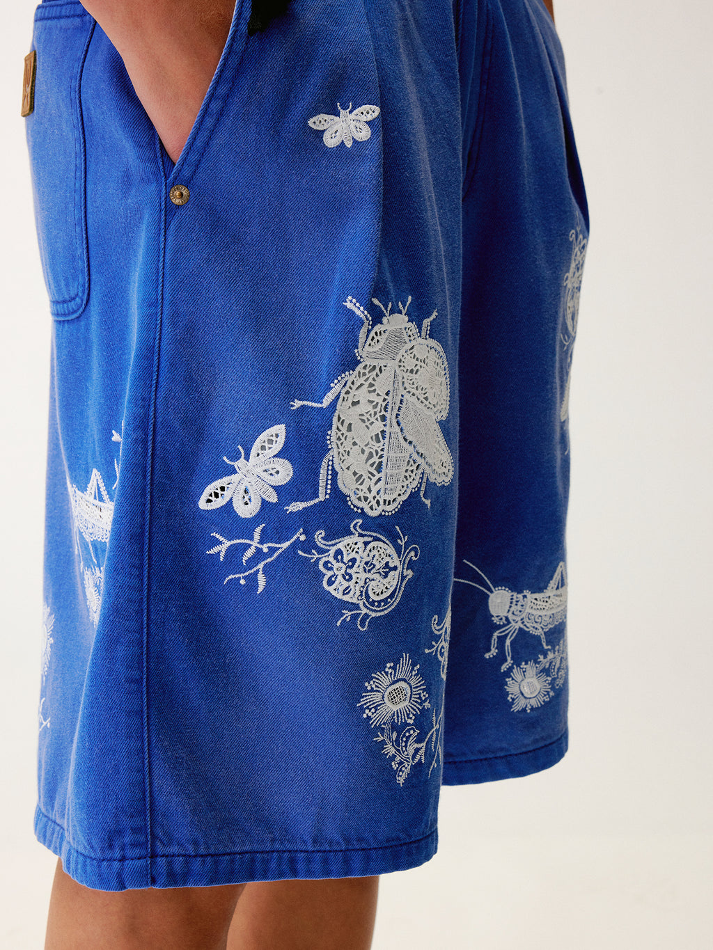 Lace insect and floral motif klein blue denim shorts