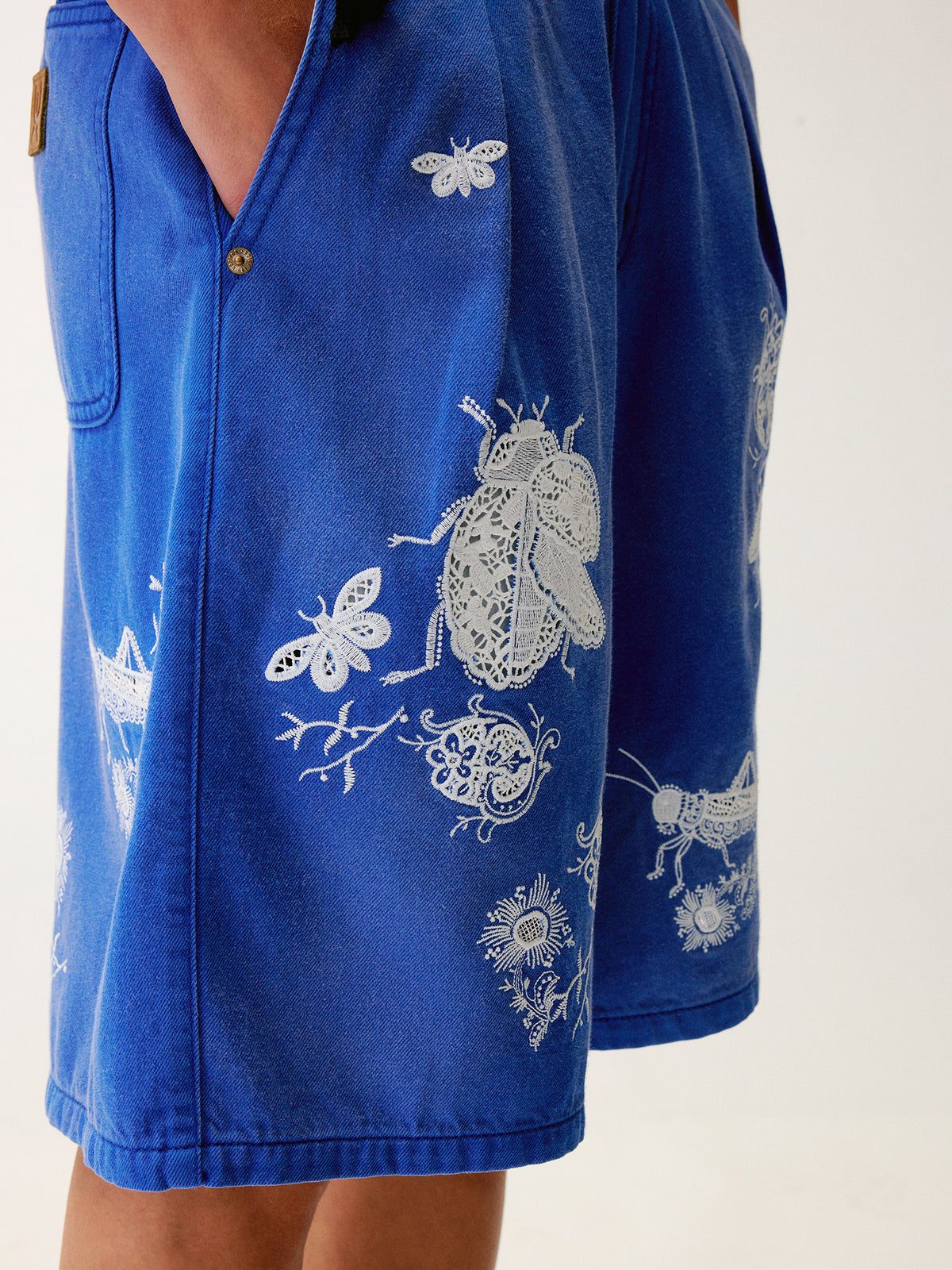 Lace insect and floral motif klein blue denim shorts
